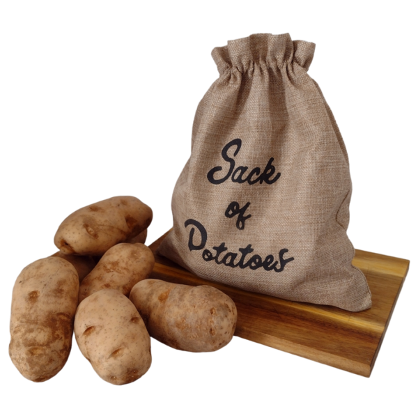 A sack of farm-fresh potatoes on a wooden cutting board